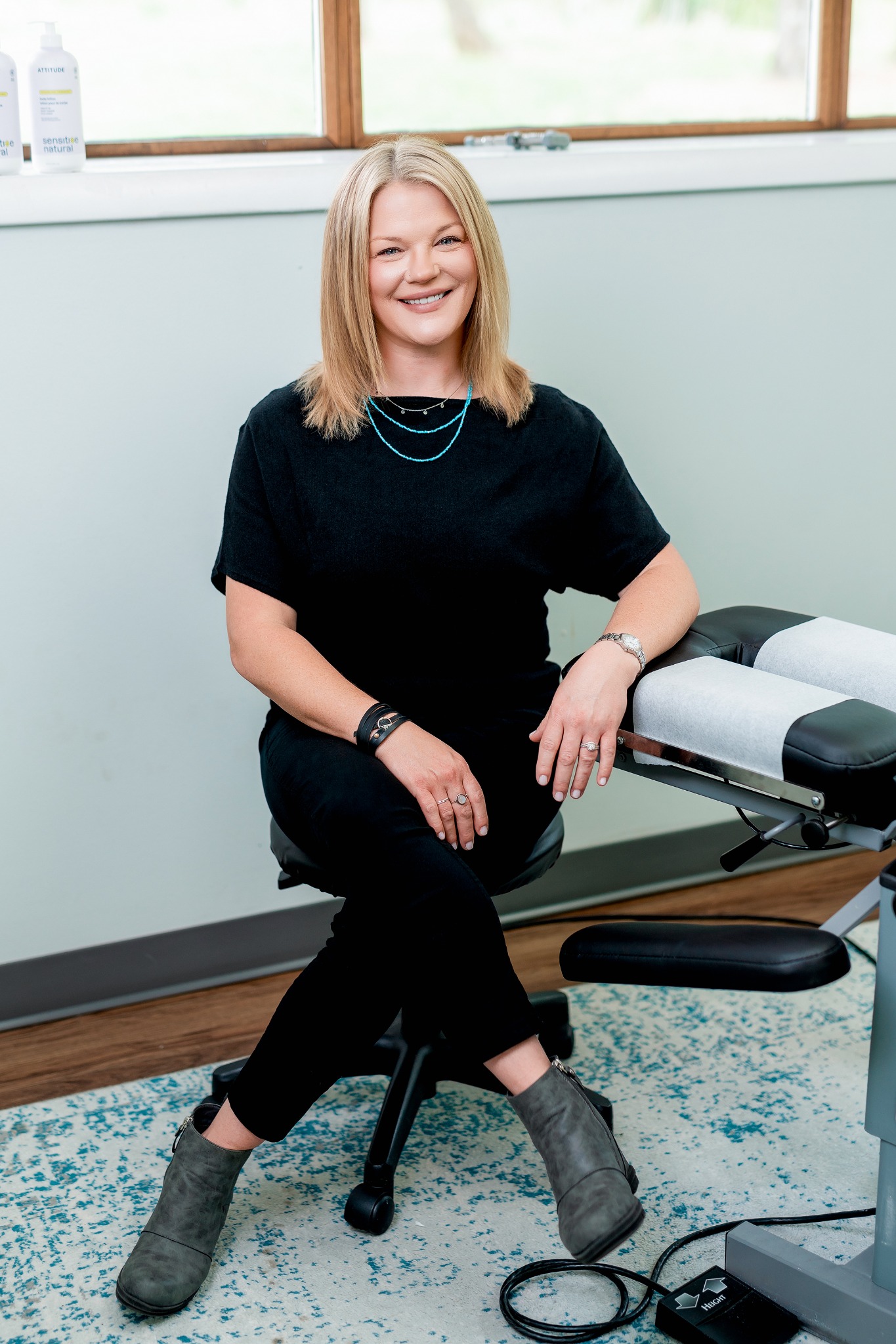 Chiropractic professional in a bright treatment room