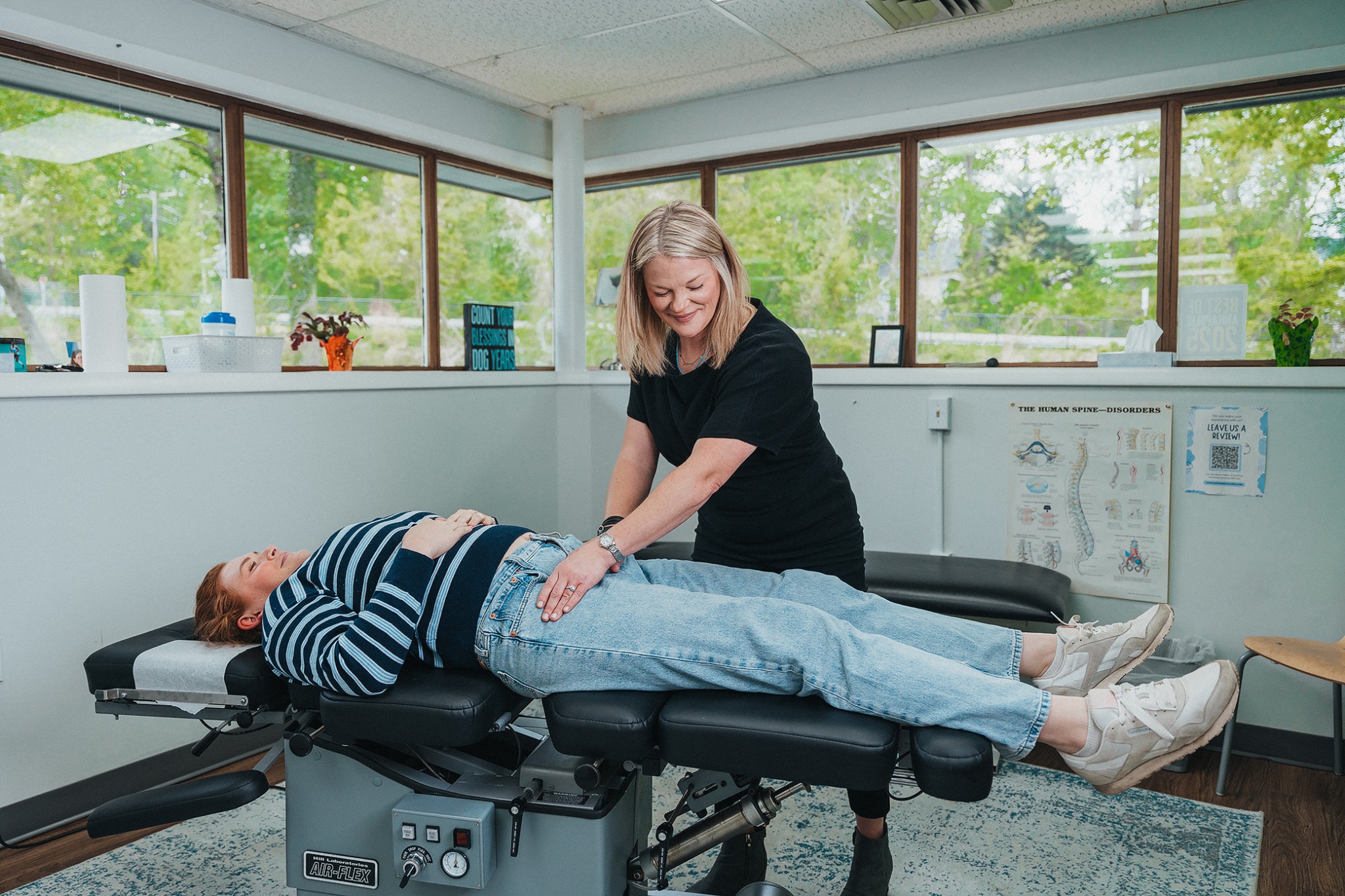 Chiropractic adjustment in a bright treatment room