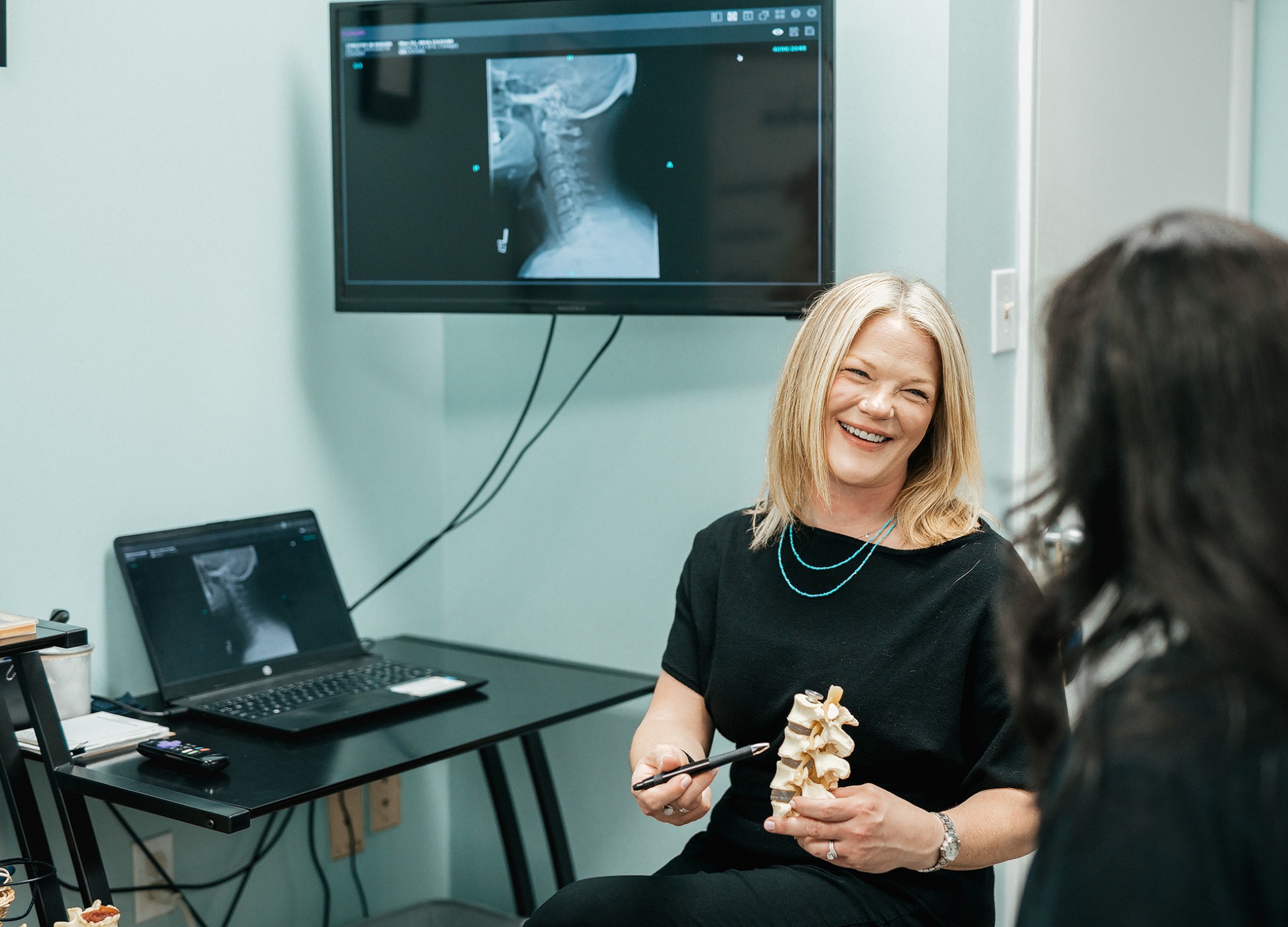 Chiropractor explaining an image to a client