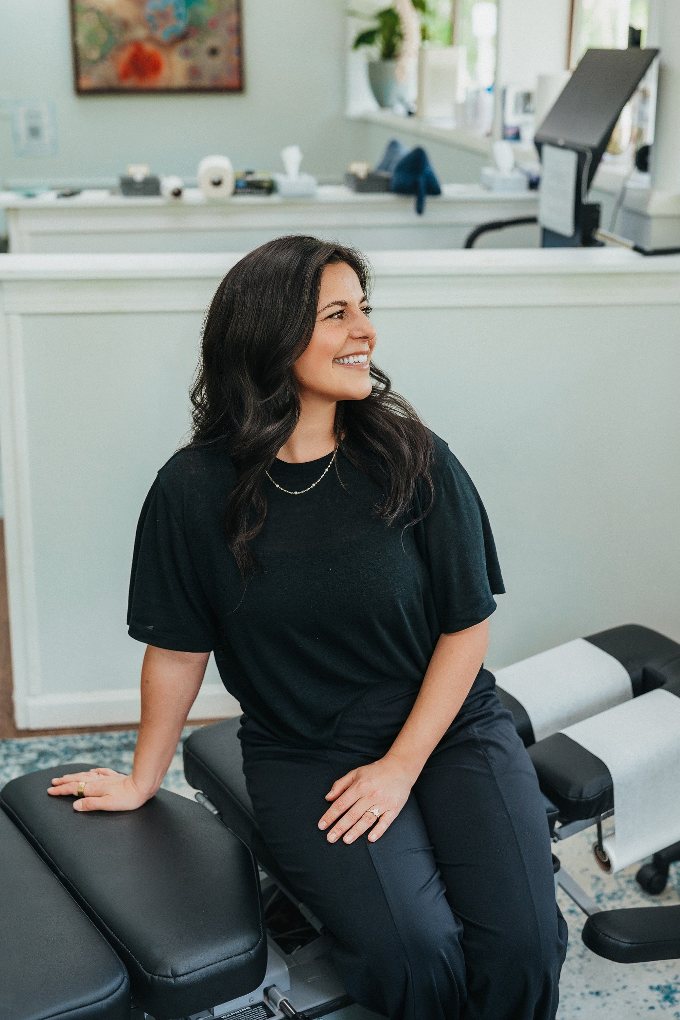Chiropractor seated in her practice
