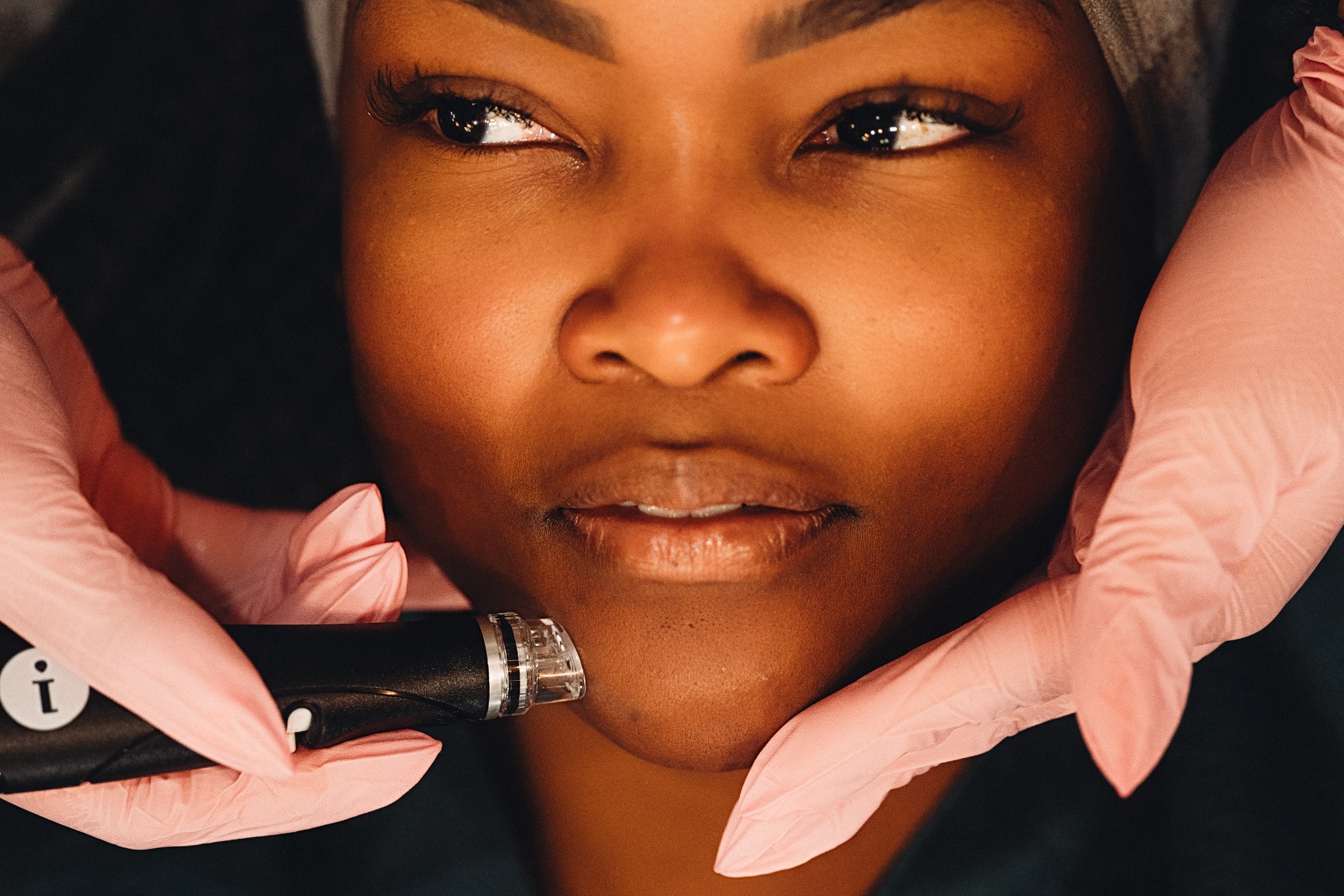Beauty professional providing a lip treatment